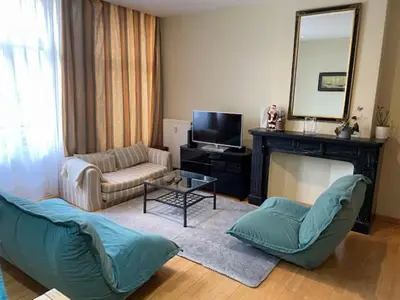a living room with a couch and a fireplace at Bourse Grand Place in Brussels