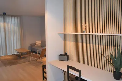 a living room with a table and a couch at YOURhouse in Geel