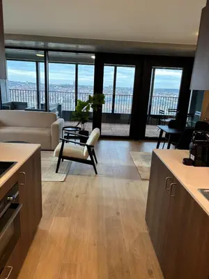 a kitchen and living room with a view of the city at Luxurious apartment in city center in Brussels