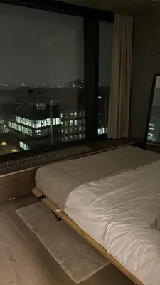 a bed in a room with a view of a city at Luxurious apartment in city center in Brussels