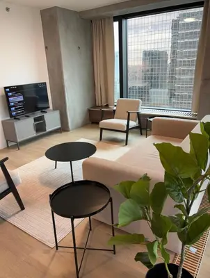 a living room with a couch and tables and a tv at Luxurious apartment in city center in Brussels