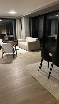 a living room with a couch and a table and chairs at Luxurious apartment in city center in Brussels