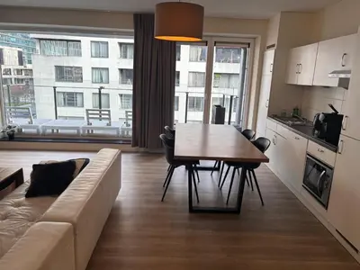 a living room with a couch and a table with chairs at Appartement 3chambres en plein centre-ville in Brussels
