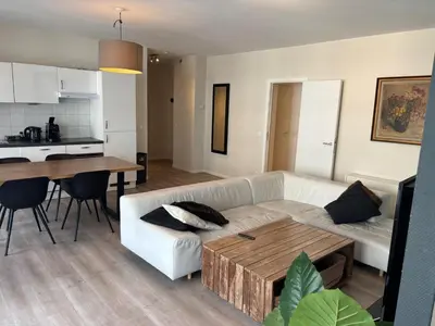 a living room with a white couch and a table at Appartement 3chambres en plein centre-ville in Brussels