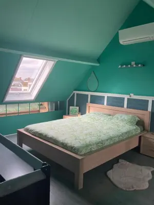 a bedroom with a bed in a room with a window at Vakantiewoning centraal in België, veel privacy, prachtig uitzicht, airco in Denderleeuw