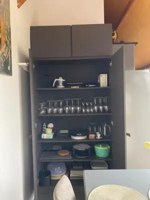a black cabinet filled with lots of pots and pans at Vakantiewoning centraal in België, veel privacy, prachtig uitzicht, airco in Denderleeuw