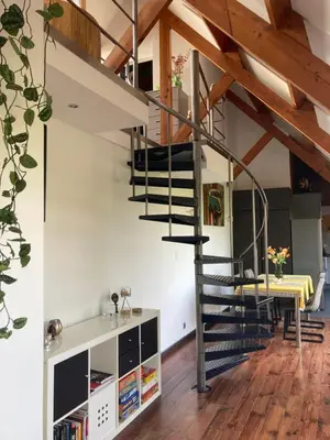 a staircase in a loft conversion with a kitchen and dining room at Vakantiewoning centraal in België, veel privacy, prachtig uitzicht, airco in Denderleeuw
