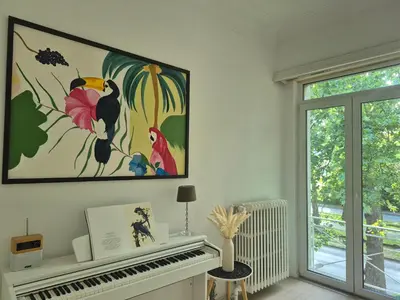 a room with a piano and a painting on the wall at Résidence Souverain 94 in Brussels