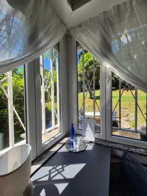 a room with windows and a table with a bottle on it at Résidence Souverain 94 in Brussels