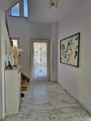 a hallway with a window and a tile floor at Résidence Souverain 94 in Brussels