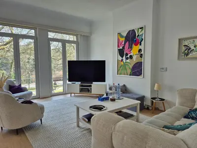 a living room with a couch and a tv at Résidence Souverain 94 in Brussels
