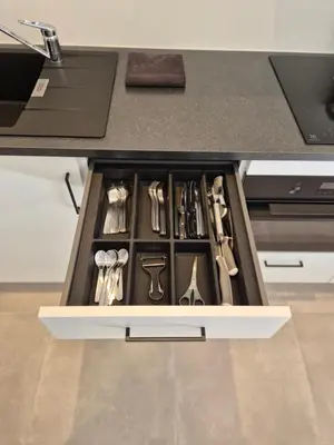 a drawer filled with utensils in a kitchen at Huis ALNA 6 in Mechelen