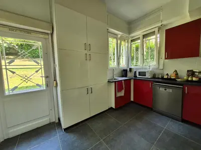 a kitchen with red and white cabinets and a window at Souverain 94 in Brussels
