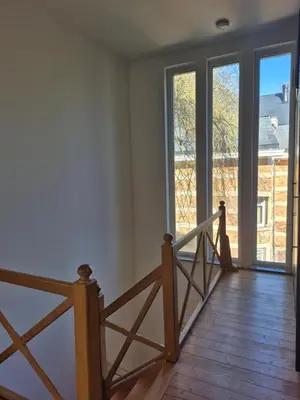 a room with a staircase and windows with a view at Souverain 94 in Brussels
