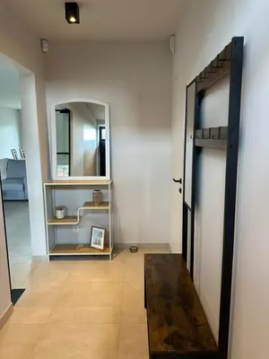 a hallway with an open door and a mirror at Sœur in Berlare
