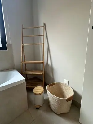 a bathroom with a chair sitting next to a sink at Sœur in Berlare