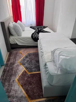 a room with two beds and a couch in it at Hébergement confort Garé de l'ouest in Brussels