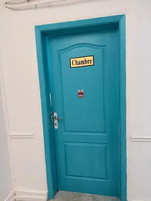 a blue door with a sign on top of it at Hébergement confort Garé de l'ouest in Brussels