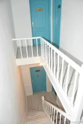 an overhead view of a staircase with a blue door at Hébergement confort Garé de l'ouest in Brussels