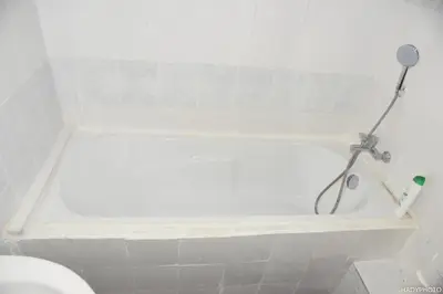 a white bath tub in a white bathroom at Hébergement confort Garé de l'ouest in Brussels