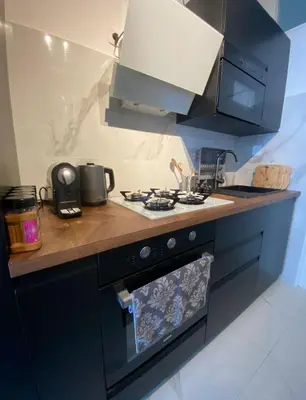 a kitchen with a stove and a counter top at Grand appartement deux chambres in Brussels
