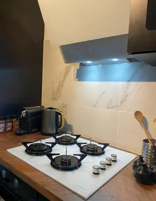 a stove top with four burners on a kitchen counter at Grand appartement deux chambres in Brussels