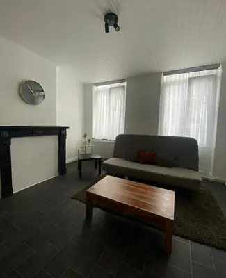 a living room with a couch and a coffee table at Grand appartement deux chambres in Brussels