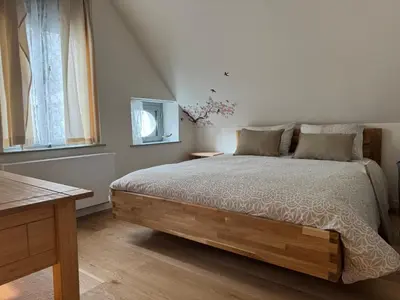 a bedroom with a bed and a table and a window at DePearl in Brussels