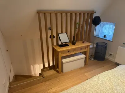 a bedroom with a wooden desk and a bed at DePearl in Brussels