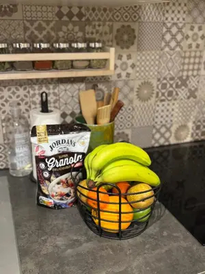 a basket of bananas and oranges on a counter at DePearl in Brussels