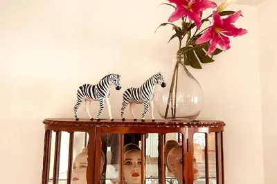 two zebra figurines on a shelf with a vase at Stylish & Spacious Flat viewing the Lovely MAS in Antwerp