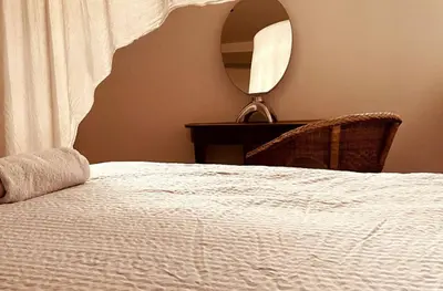 a bedroom with a bed and a mirror and a table at Stylish & Spacious Flat viewing the Lovely MAS in Antwerp