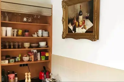 a mirror hanging on a wall in a kitchen at Stylish & Spacious Flat viewing the Lovely MAS in Antwerp