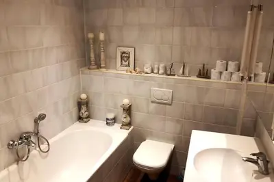 a bathroom with a tub and a toilet and a sink at Stylish & Spacious Flat viewing the Lovely MAS in Antwerp