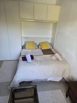 a small bedroom with a bed with towels on it at Studio cozy avec terrasse in Vilvoorde