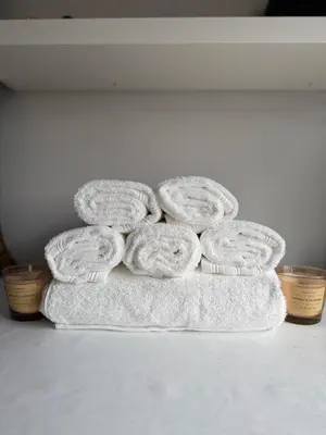 a pile of towels sitting on top of a counter at Ngipe's Tomorrowland in Antwerp