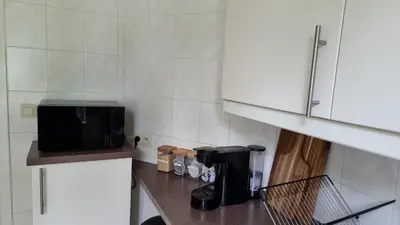 a kitchen with a counter top with a microwave at Maison Agathe in Brussels