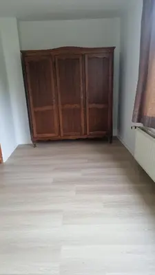 a room with wooden cabinets and a wooden floor at Maison Agathe in Brussels