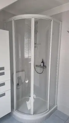 a glass shower in a bathroom with a toilet at Maison Agathe in Brussels