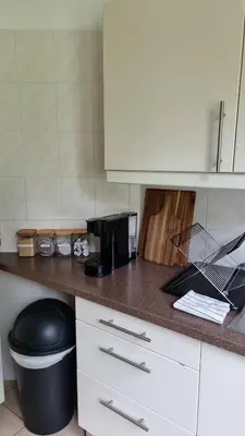 a kitchen with a counter top with a trash can at Maison Agathe in Brussels