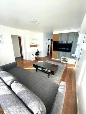 a living room with a couch and a flat screen tv at Green Spot Meise - 15 min from Brussels with free parking & Self check-in in Meise