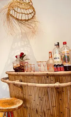 a table with bottles of alcohol and glasses on it at Charming & Spacious Duplex viewing the lovely MAS in Antwerp