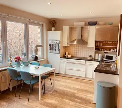 a kitchen with a table and chairs in a kitchen at Charming & Spacious Duplex viewing the lovely MAS in Antwerp