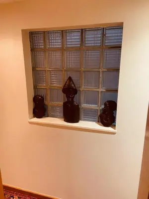 a window with three figurines on a shelf at Charming & Spacious Duplex viewing the lovely MAS in Antwerp
