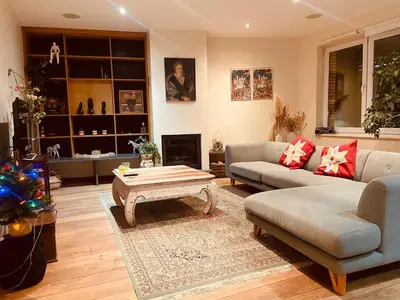 a living room with a couch and a coffee table at Charming & Spacious Duplex viewing the lovely MAS in Antwerp