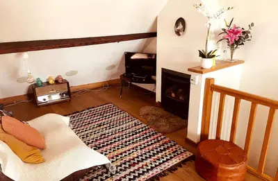 a living room with a fireplace and a couch at Cozy & Spacious Duplex with an Amazing Terrace in Antwerp