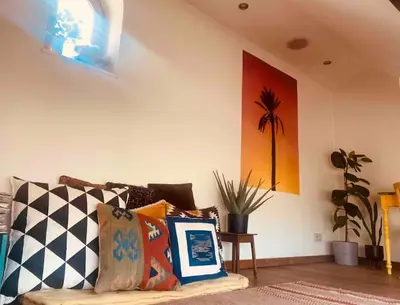 a living room with a couch with pillows on it at Cozy & Spacious Duplex with an Amazing Terrace in Antwerp