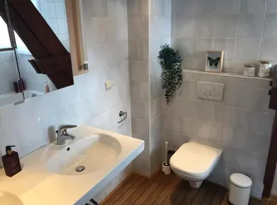 a bathroom with a sink and a toilet at Cozy & Spacious Duplex with an Amazing Terrace in Antwerp