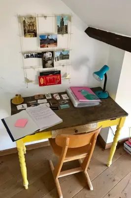 a yellow desk with a table with a chair and a desk at Cozy & Spacious Duplex with an Amazing Terrace in Antwerp