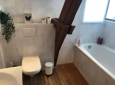 a bathroom with a tub and a toilet and a sink at Cozy & Spacious Duplex with an Amazing Terrace in Antwerp